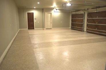 Empty two-car garage with polished floor and beige walls.