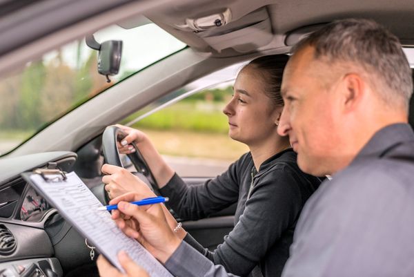 Student taking driving practical test.