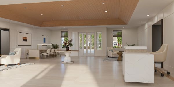 Bright, modern lobby with wooden ceiling and sleek furniture.