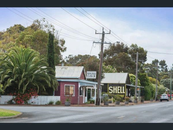 Small cafe and Shell gas station sign on a quiet street.