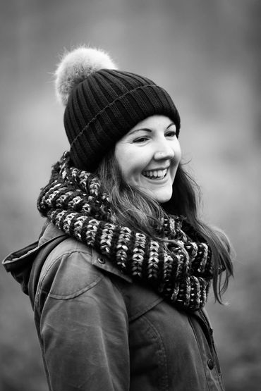 A black and white portrait of Keira, looking happy on a winter walk. Simon White Photography