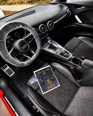 Interior of a modern Audi car with brochure on seat.