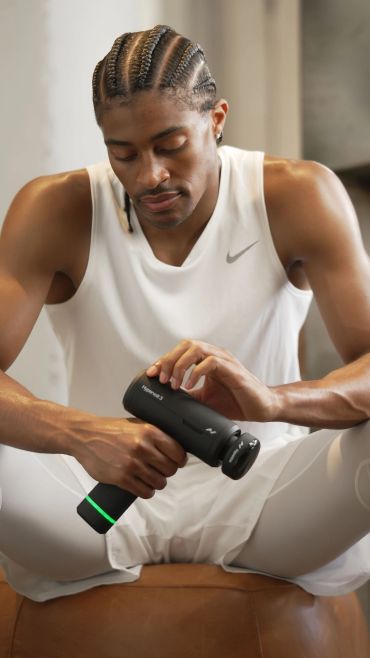 Man turning on massage gun.