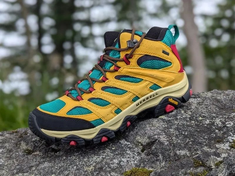 Colorful hiking boot on a rock outdoors.
