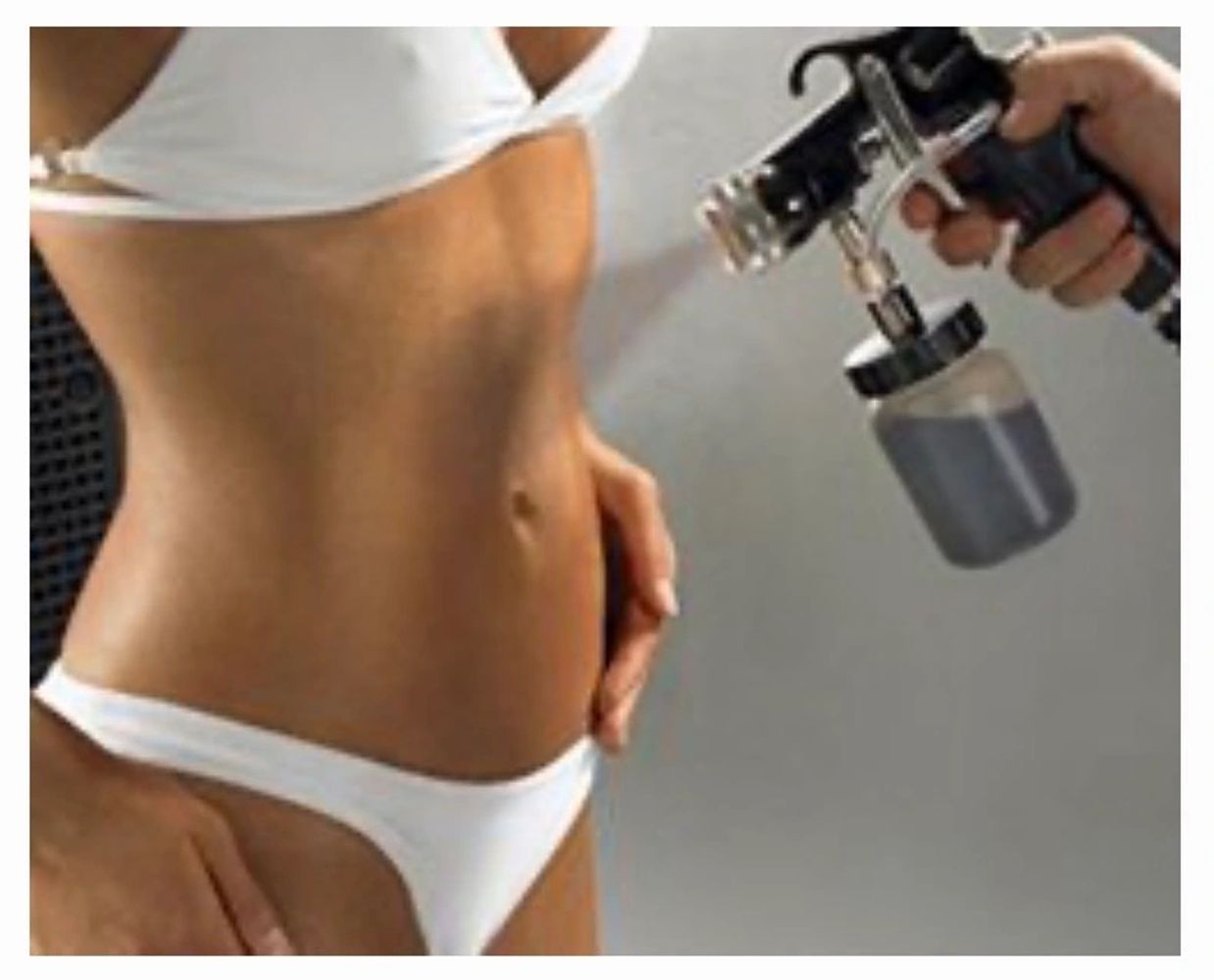 A woman getting a spray tan on her torso and legs.
