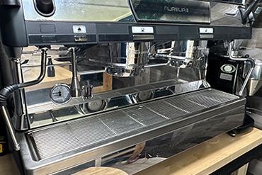 A modern espresso machine on a wooden counter.