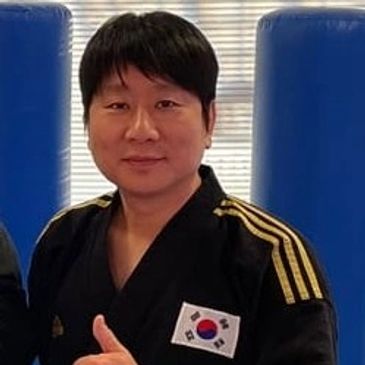 a taekwondo master gives a thumbs up