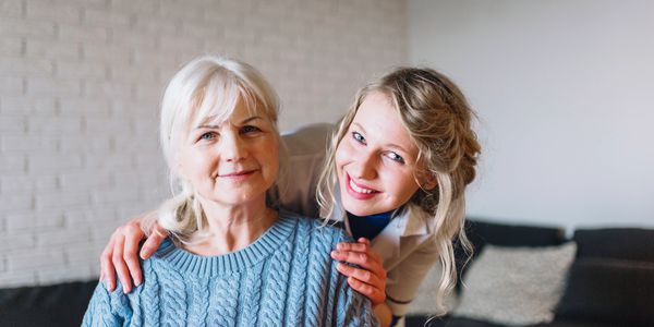 Promoting independence and dignity through personalized care, a woman embraces an elder.