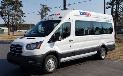 White transit van of Delta Area Transit Authority parked outdoors.