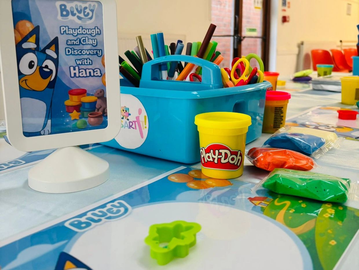 Playdough and clay crafting setup with colorful tools.