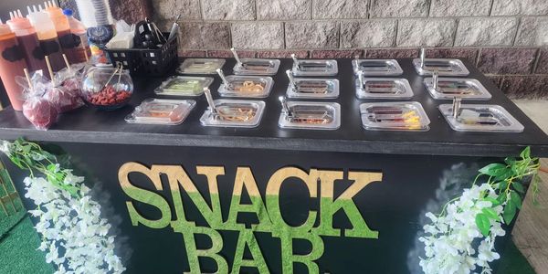 A snack bar with various toppings and sauces arranged neatly.