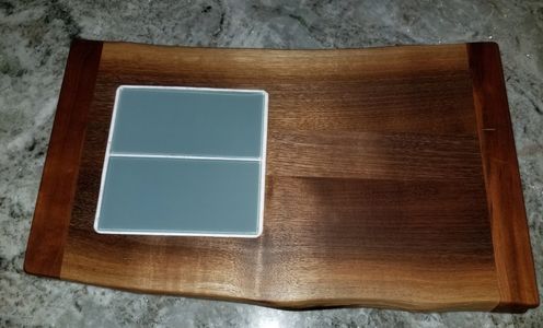 Green Glass Subway tile embedded into live edge walnut. 