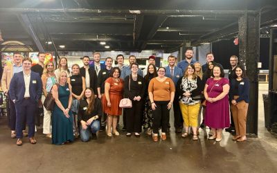 Group photo at an indoor event with diverse attendees.