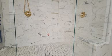 Calacatta marble steam shower with a bench and recessed niche