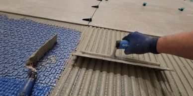 Thin-set mortar application over floor membrane