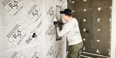 Installation of a waterproof shower membrane over shower walls