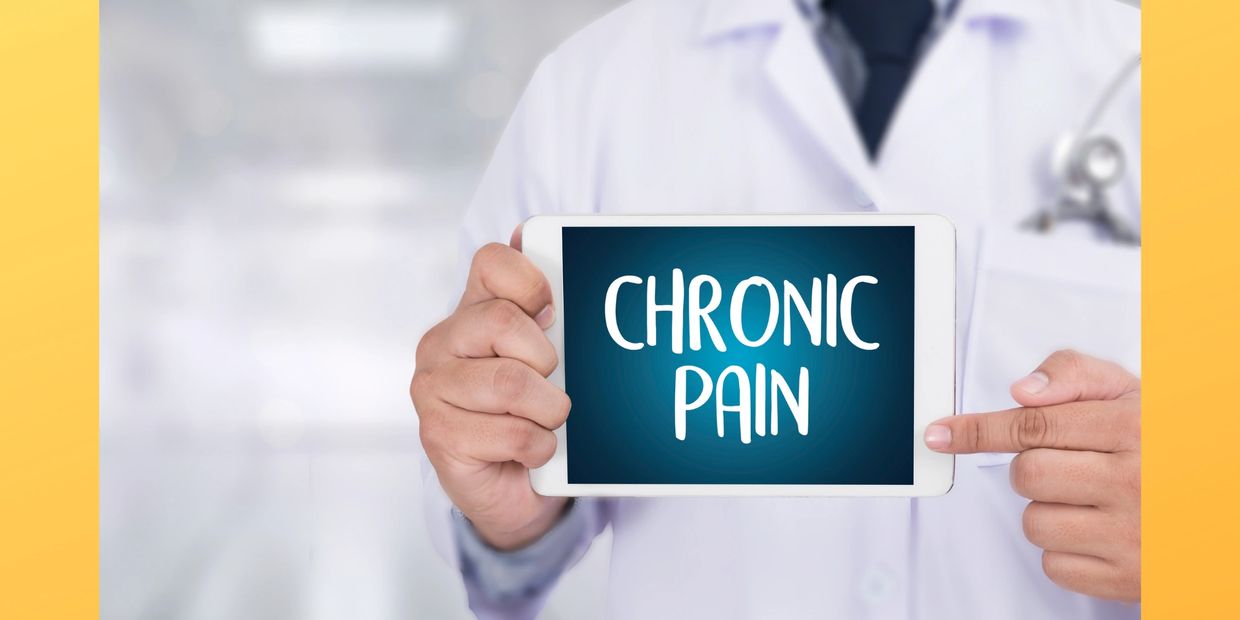 doctor holding chronic pain sign