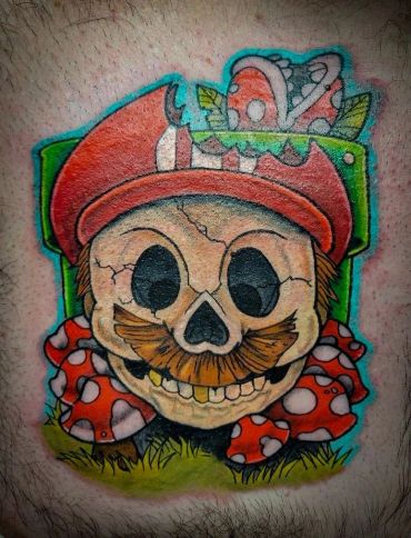 Colorful tattoo of a skull with a mustache and mushrooms wearing a red hat.