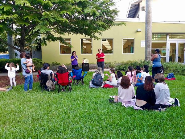 People sitting on a lawn.