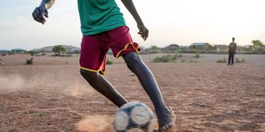 A young refugee playing football