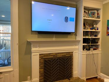 Flatscreen tv mounted over fireplace in plaster, boulder colorado