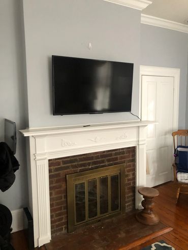 Plaster tv installed over fireplace, Littleton colorado