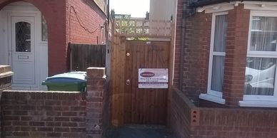 close boarded wooden gate with added trellis