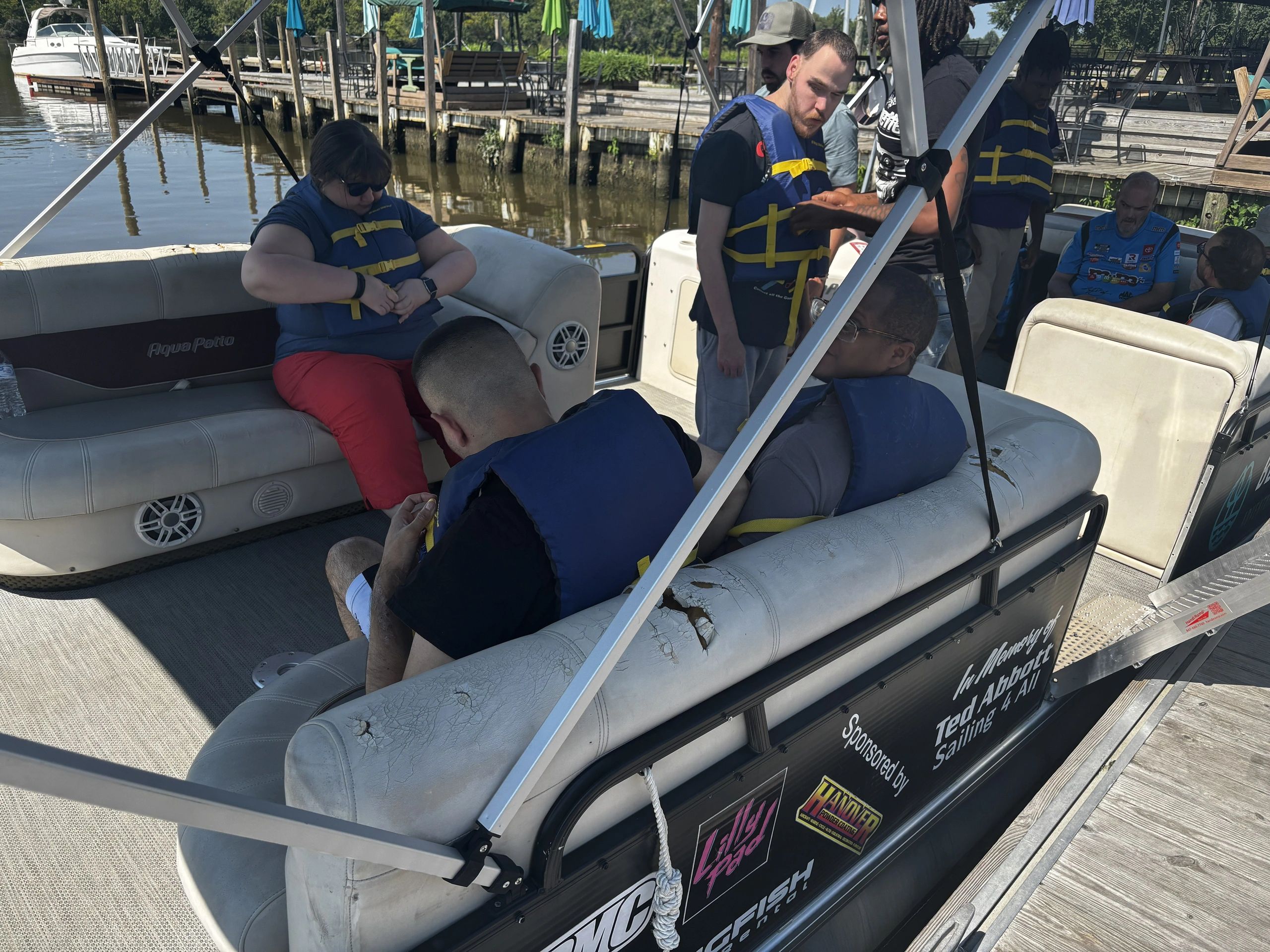 Individuals participating in a community boating experience with NDS Group Day Support.