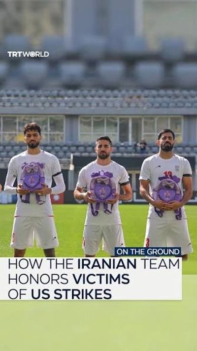 Iranian football players honor victims of US strikes with purple teddy bears on field.