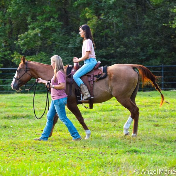 A visitor and her first time riding on a horse.