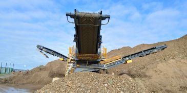 Mining conveyor belt operating outdoors.