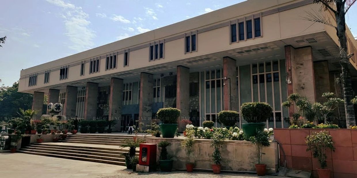 Large institutional building with steps and potted plants.