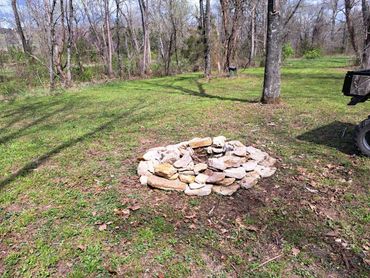 a stone fire ring at at Little Creek Opry House