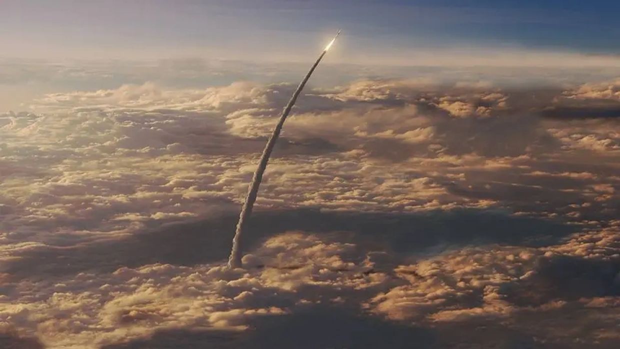 Rocket launch leaving a trail through the clouds.