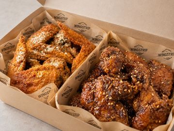 Box of seasoned and crispy fried chicken wings.