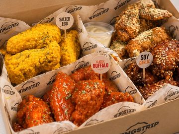 Assorted flavored chicken wings in a box.