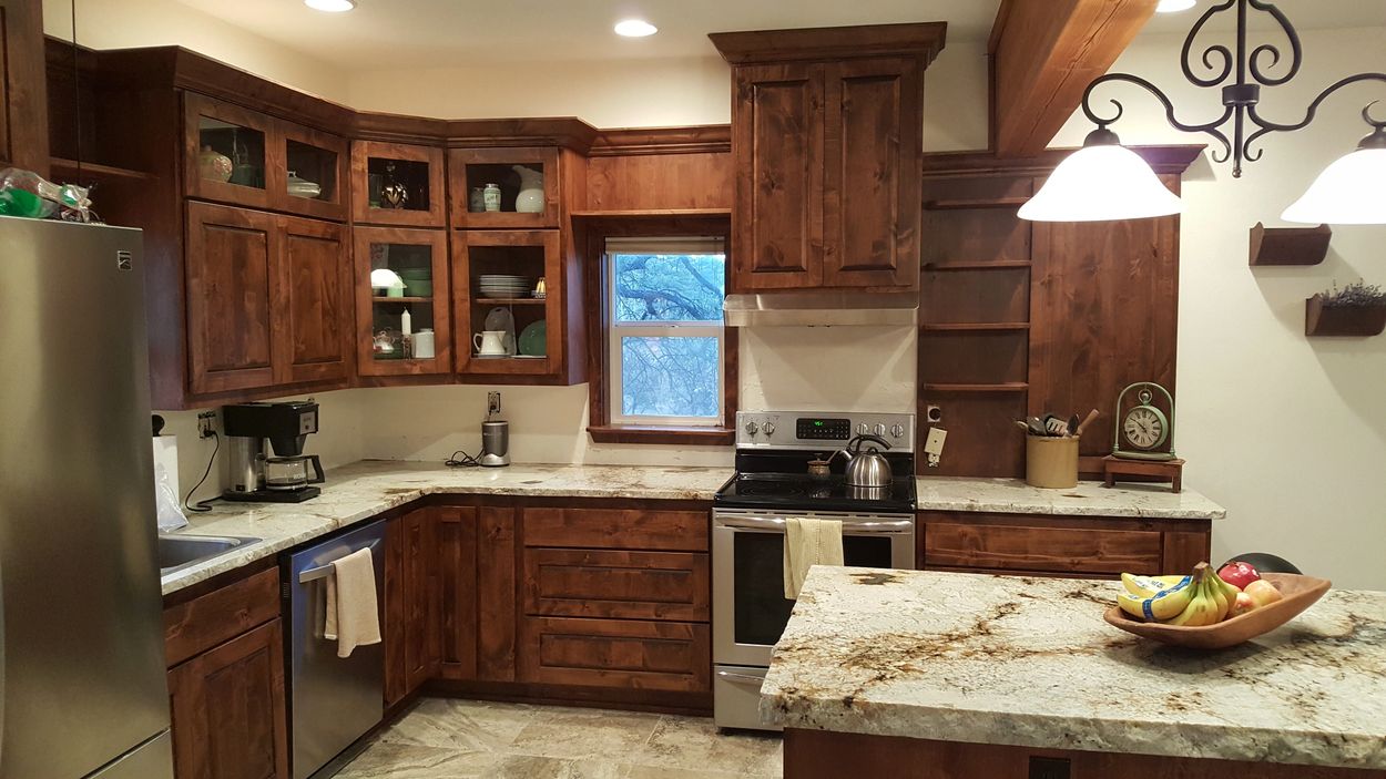 Pagosa cabinets, dark knotty alder custom kitchen cabinets, with glass doors.