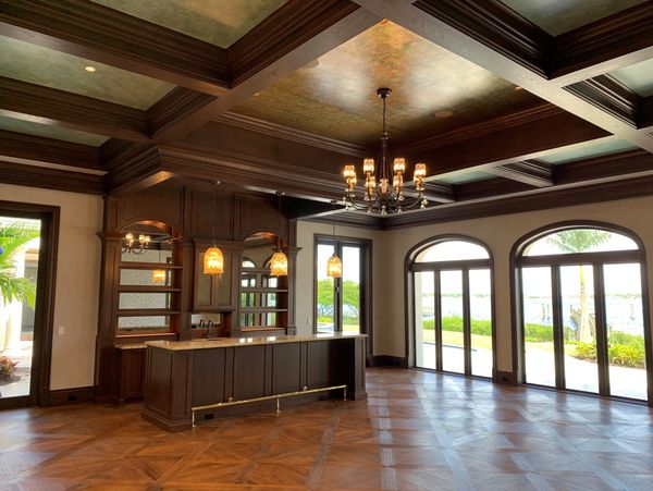 Elegant room with wooden ceiling and large windows.