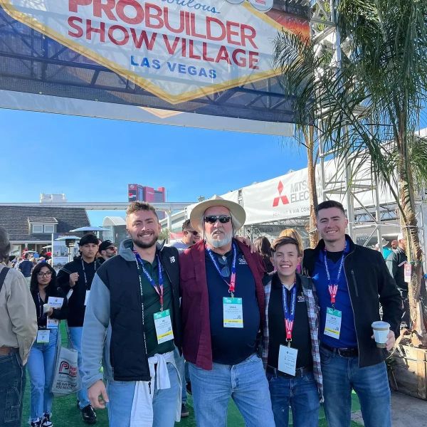 Group of four people at ProBuilder Show Village in Las Vegas.
