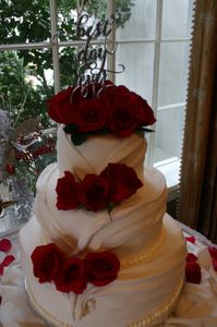Three-layer wedding cake with rose decorations