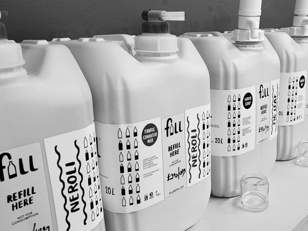 A shelf of household and personal cleaning products for refill