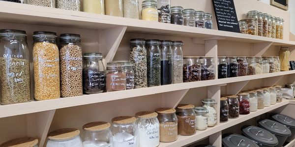 Shelves of glass jars filled with dried products for refilling