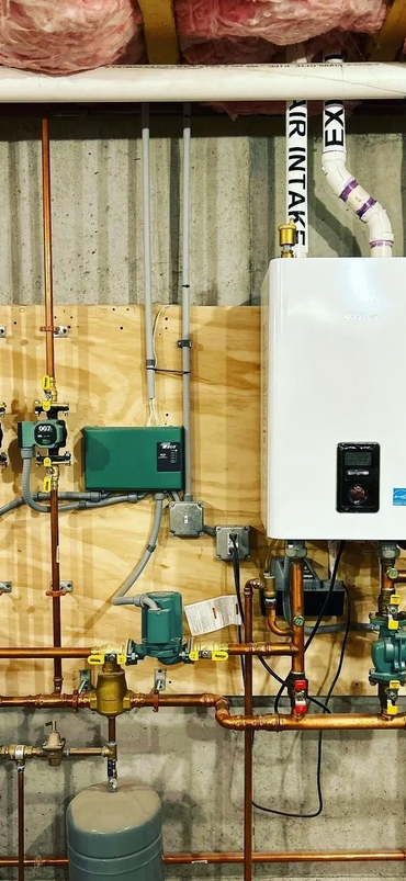 Well-organized home plumbing and heating system with copper pipes and a water heater.