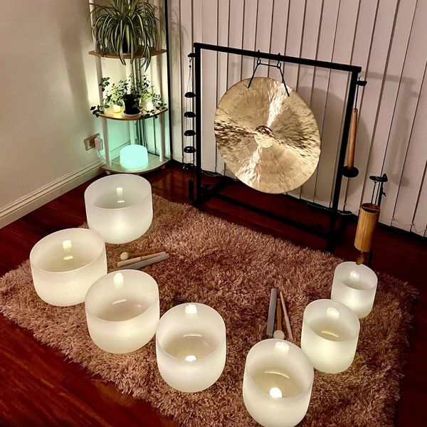 Seven crystal singing bowls, a gong and a  Koshi chime are in the room for Reiki sound healing.