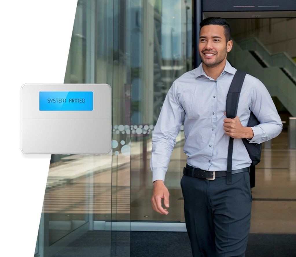 employee leaving office confidently knowing the security system is armed