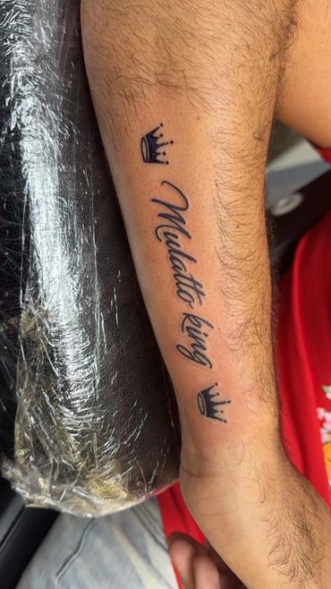 script lettering and crown tattoo