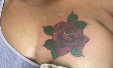 rose chest coverup tattoo