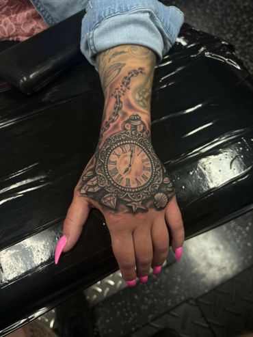 womens black and grey clock hand tattoo done by dj guinan cape coral florida tattoos near me