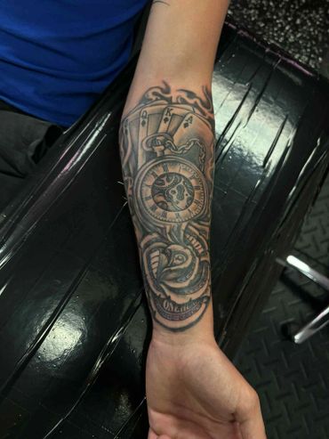 mens badass forearm tattoo clock playing cards and money rose tattoo shop artist near me