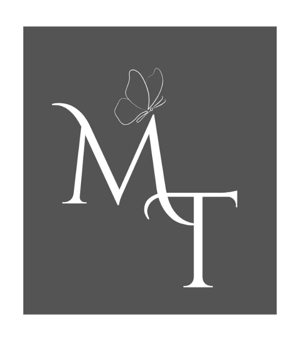 Elegant white MT logo with a butterfly on a gray background.